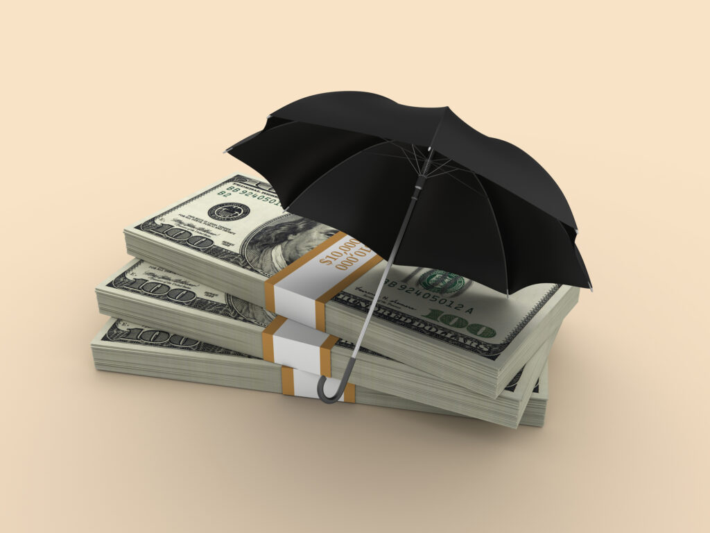 Stacks of money under an umbrella, symbolising how Diaspora Funeral Insurance offers protection that savings alone cannot provide.