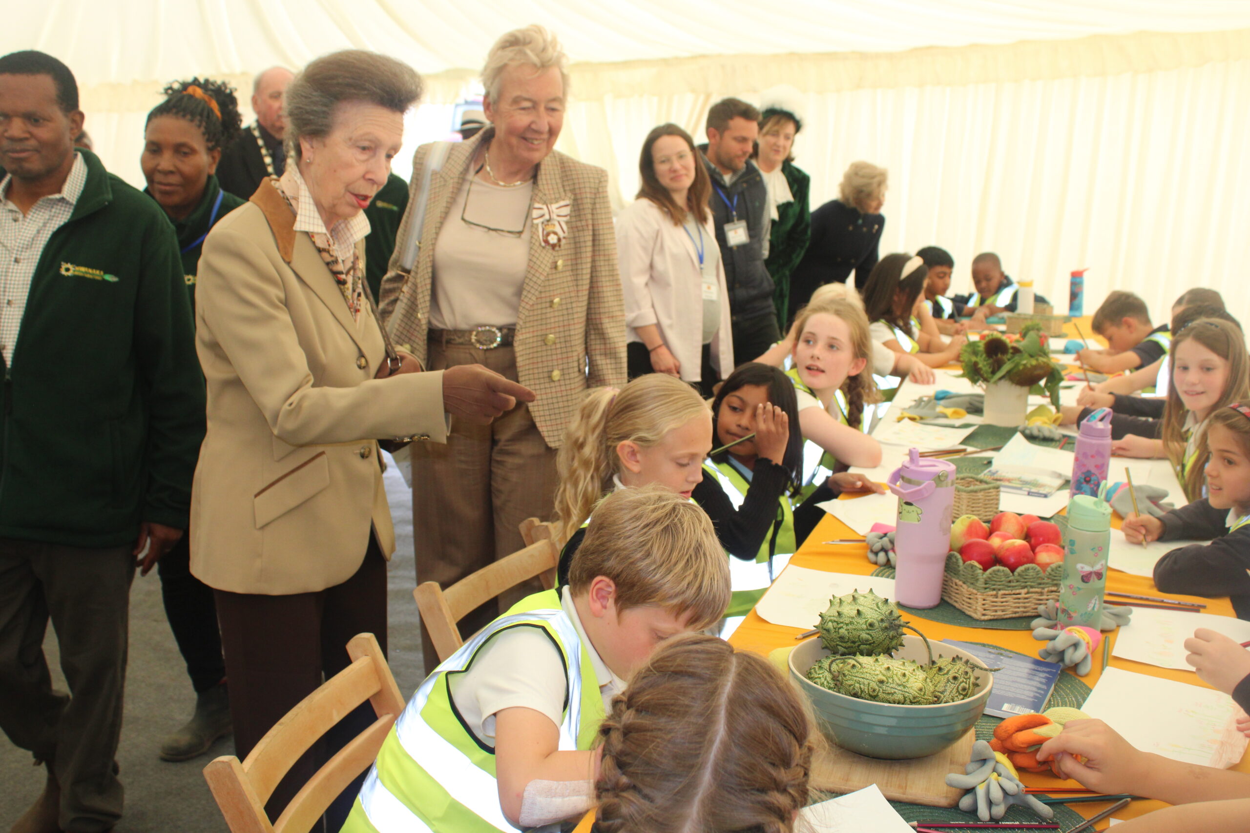 Princess Anne visits Mwanaka Farm in Cambridge, interacting with Milton Primary Academy pupils attending the event, celebrating diaspora farming, education, and community engagement