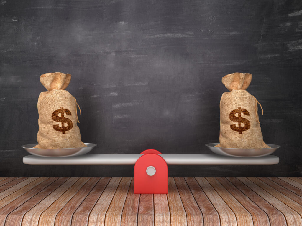 Two balanced money bags on a seesaw representing financial balance and stability — concept for How Africans in the diaspora can build financial stability.