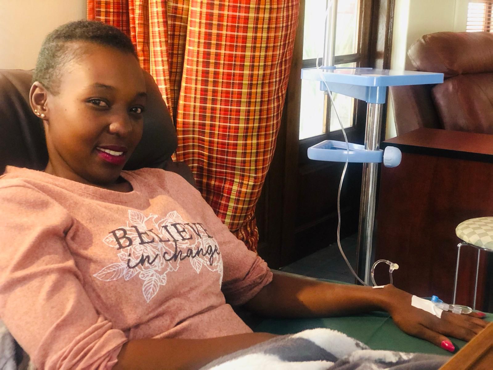 Marlene Chiedza Gadzirayi smiling during a chemotherapy session while undergoing treatment for stage three colorectal cancer.
