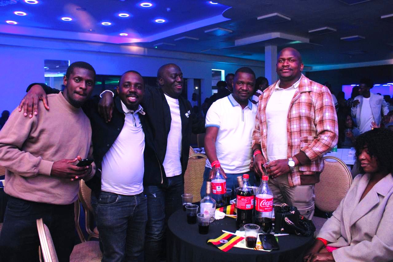 Ugandan brothers and friends sharing drinks and enjoying each other’s company during the Uganda @ 63 Independence celebrations in London.