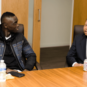Diaspora Insurance CEO Jeff Madzingo speaking while Papiss Ciss&eacute; listens attentively during a discussion on business and community leadership.