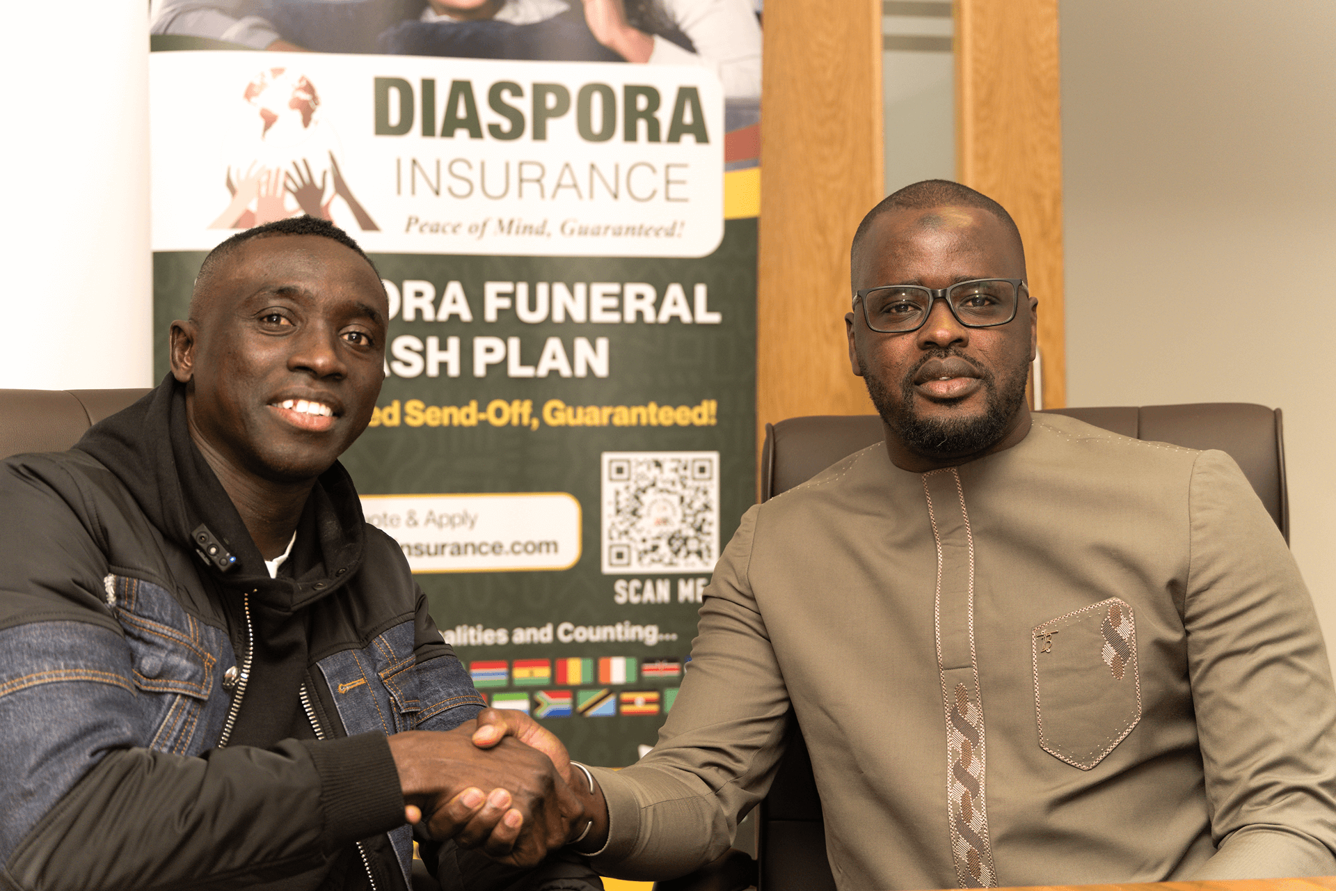 api Cissé posing for a photograph in the Diaspora Insurance boardroom alongside Manchester-based Senegalese community leader Papr Ngor Thiaré.