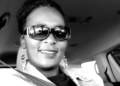 imbabwean care worker in UK dies &ndash; black and white portrait of a woman wearing sunglasses, seated in a car