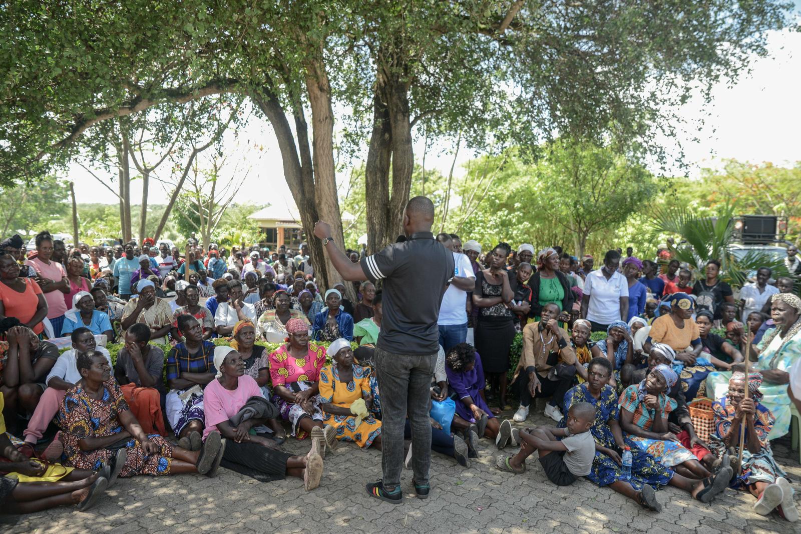 Beneficiaries of food donations in Homabay County, Kenya, gathered at a Christmas party receiving gifts and food supplies
