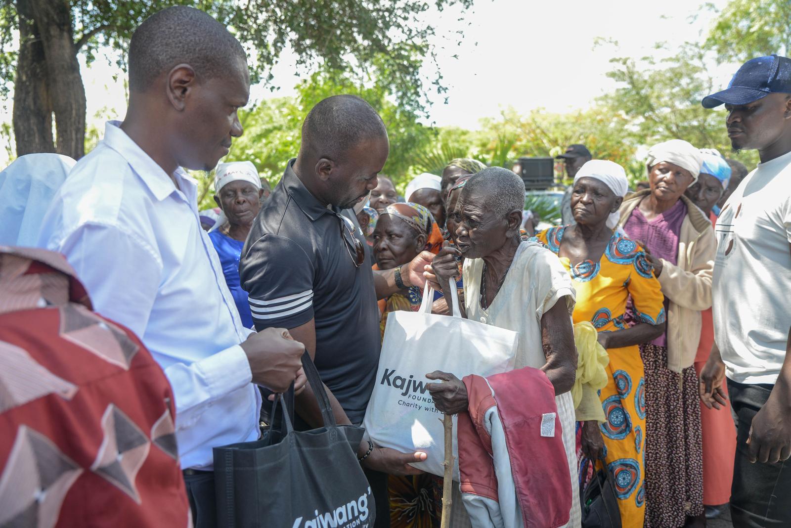 Elderly women in Homabay, Kenya, receiving food donations provided by Diaspora Insurance.