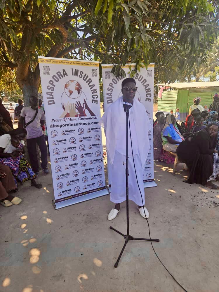 ALT TextAbdullah Aid Director Alhaji Ousmanme speaking at the handover ceremony of food donations in Brikama Manduar, The Gambia.