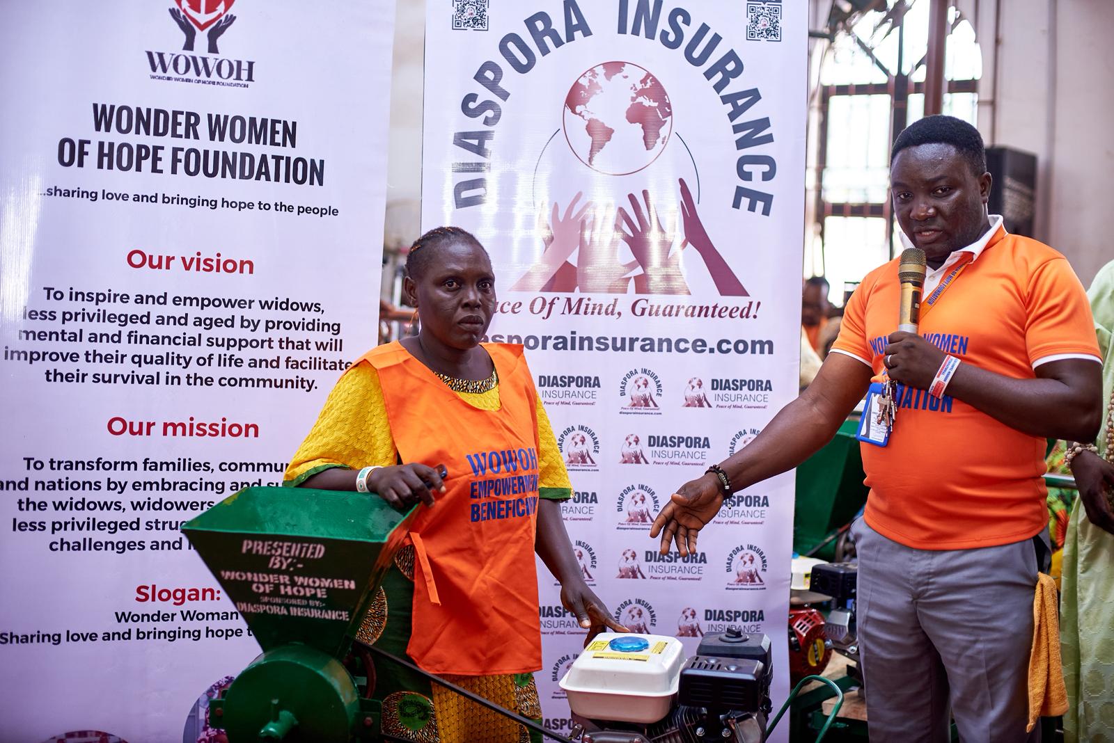 A member of Wonder Women of Hope handing over a package of grinding meals to a smiling beneficiary during a community support event.